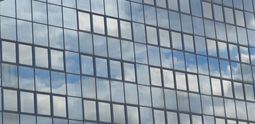 Clouds reflecting in a commercial glass curtain wall