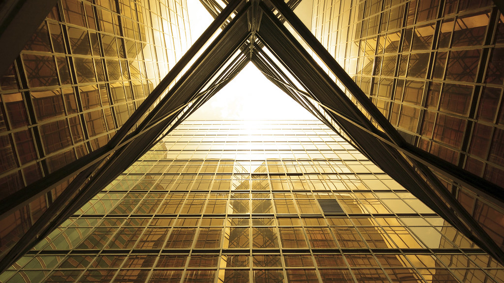 Modern commercial office building with a full glass facade